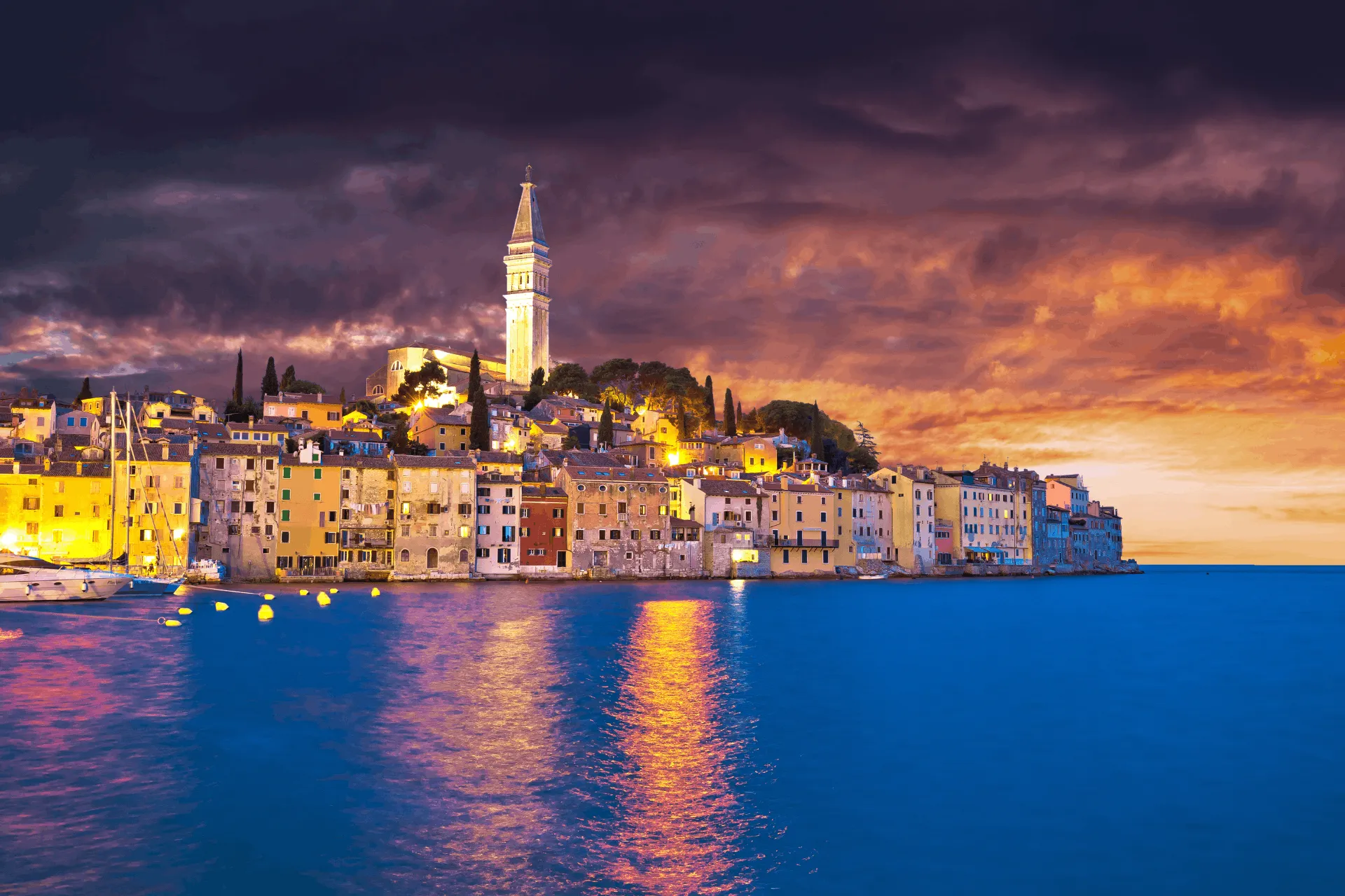 view on city of Rovinj from the sea during nighttime