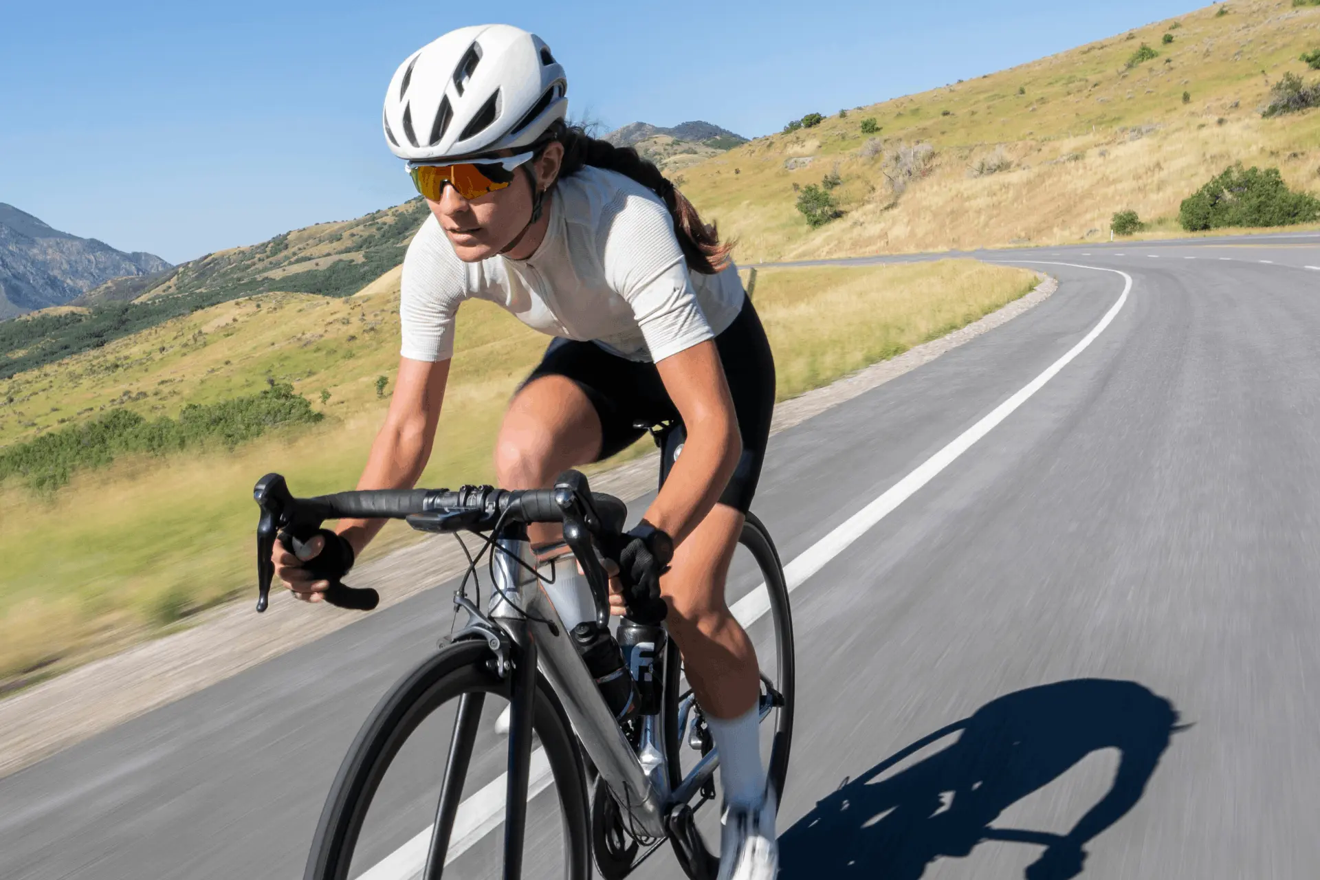 cycling on the road with a nice weather and scenic hills behind