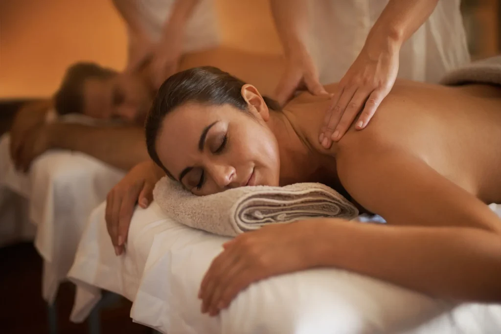 women laying on massage bed being massaged in luxury setting