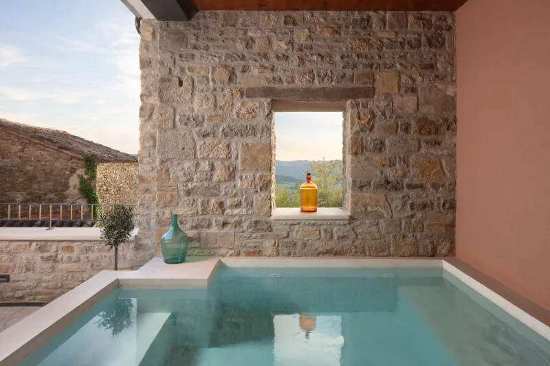 pool in Villa motovun with a stone wall overlooking a valley